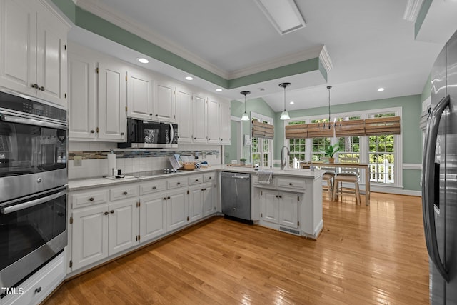 18 Acornridge Ct, Durham, NC 27707 - kitchen featuring stainless steel appliances, crown molding, a peninsula, tasteful backsplash, and white cabinetry