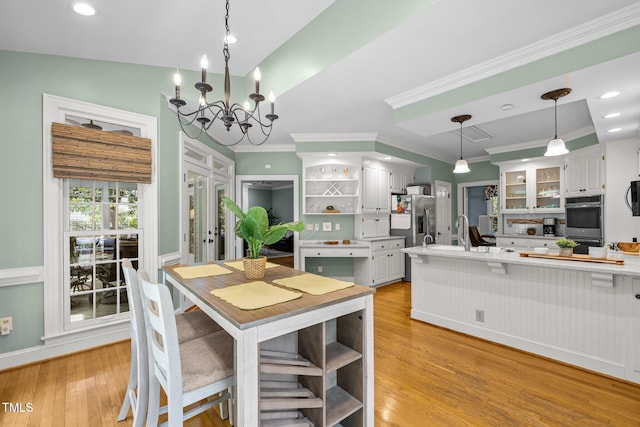 18 Acornridge Ct, Durham, NC 27707 - kitchen featuring open shelves, stainless steel appliances, light countertops, white cabinets, and light wood finished floors