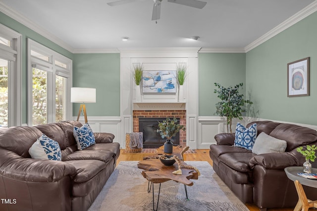 18 Acornridge Ct, Durham, NC 27707 - living area featuring wood finished floors, ornamental molding, ceiling fan, a brick fireplace, and wainscoting