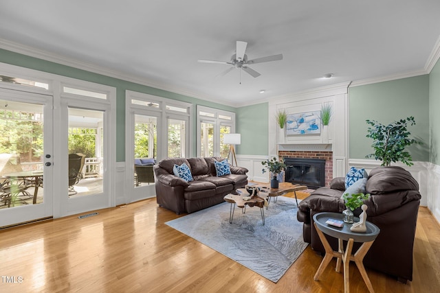 18 Acornridge Ct, Durham, NC 27707 - living room featuring ceiling fan, a brick fireplace, plenty of natural light, ornamental molding, and wood finished floors