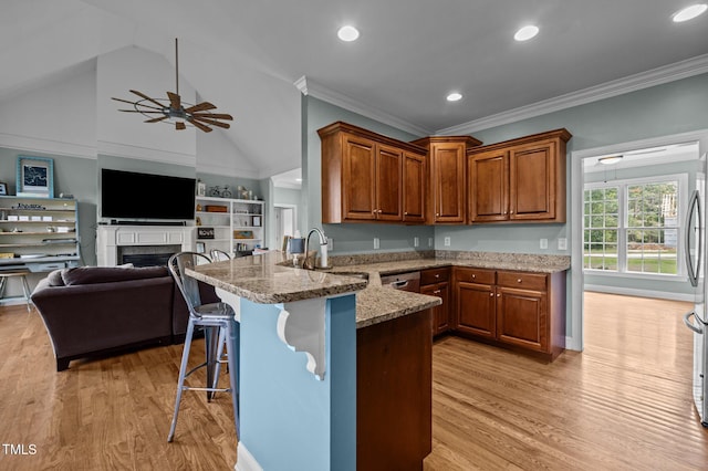 281 Derwin Dr, Timberlake, NC 27583 - kitchen featuring a peninsula, a sink, light wood-style floors, light stone countertops, and crown molding