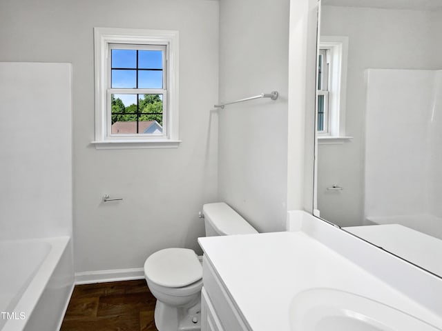 full bath featuring baseboards, wood finished floors, toilet, and vanity