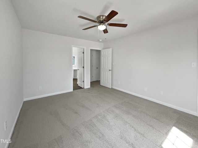 unfurnished bedroom featuring baseboards, carpet floors, and ceiling fan