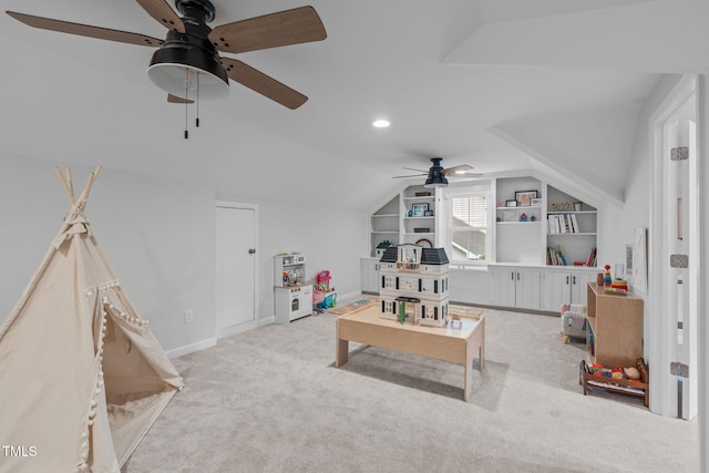 rec room featuring ceiling fan, lofted ceiling, built in shelves, carpet, and baseboards