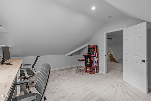 carpeted office featuring lofted ceiling and baseboards