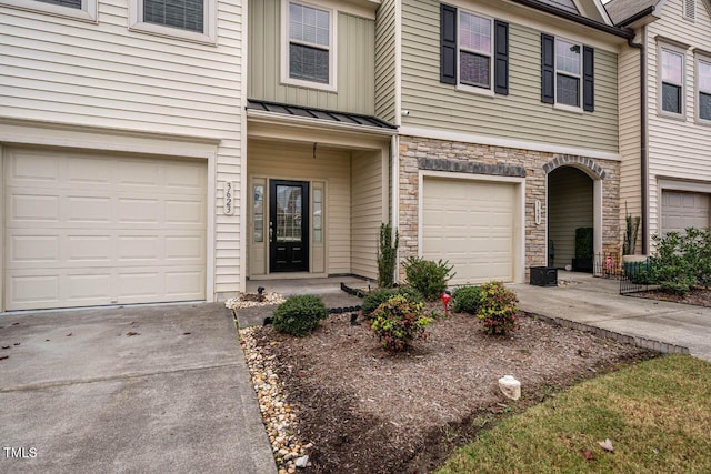 3623 Landshire View Ln, Raleigh, NC 27616 - view of property with a standing seam roof, driveway, stone siding, and an attached garage