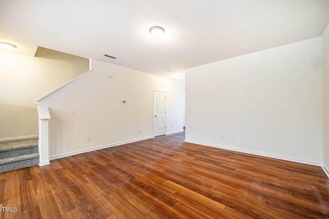 3623 Landshire View Ln, Raleigh, NC 27616 - unfurnished living room with stairway, wood finished floors, and baseboards