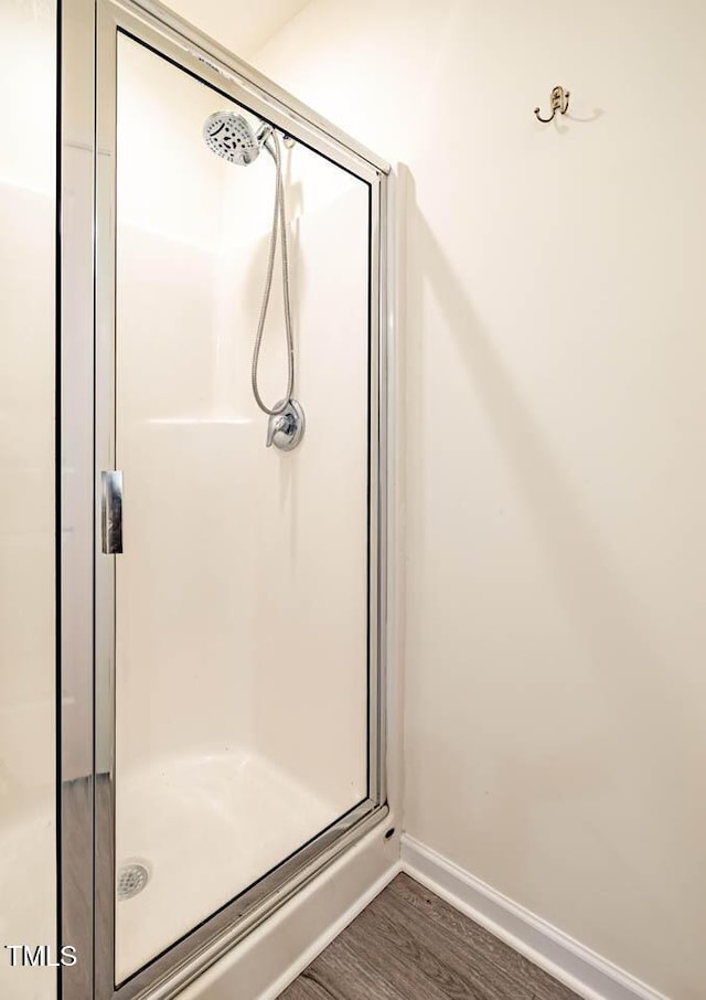 3623 Landshire View Ln, Raleigh, NC 27616 - full bathroom with a stall shower, baseboards, and wood finished floors
