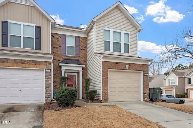view of front facade with concrete driveway, an attached garage, brick siding, and stone siding