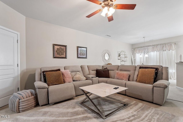 carpeted living room featuring a ceiling fan