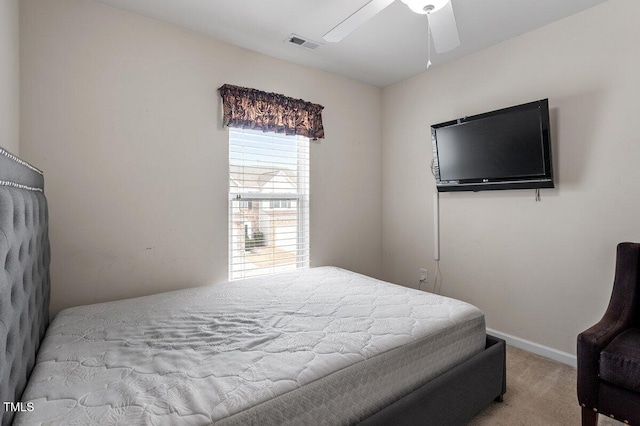 carpeted bedroom featuring baseboards and ceiling fan