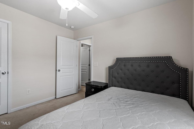 carpeted bedroom with baseboards and a ceiling fan