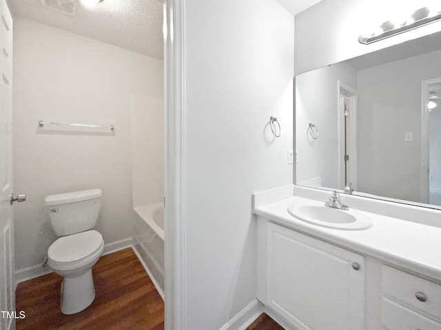 5612 Tealbrook Dr, Raleigh, NC 27610 - full bathroom with toilet, wood finished floors, vanity, and baseboards