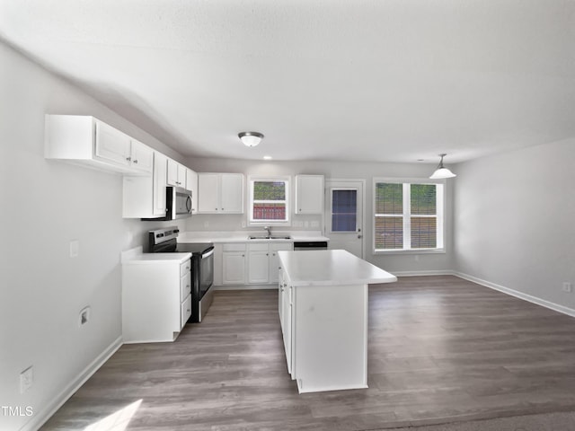 5612 Tealbrook Dr, Raleigh, NC 27610 - kitchen featuring stainless steel appliances, a sink, baseboards, white cabinets, and a center island