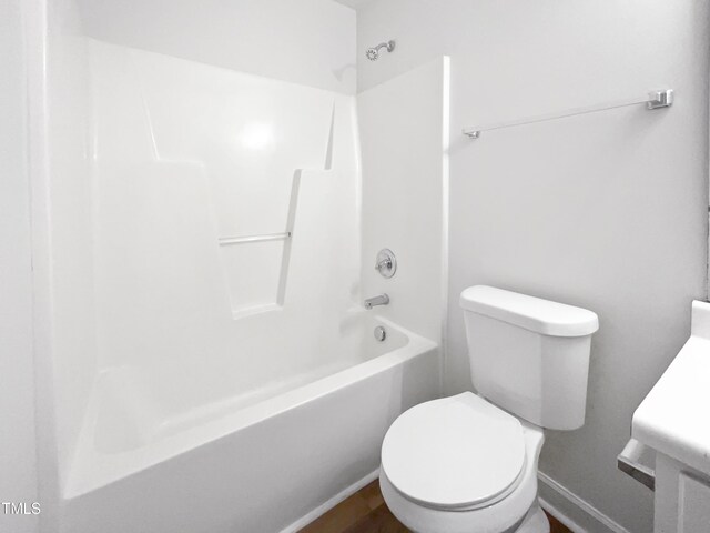 5612 Tealbrook Dr, Raleigh, NC 27610 - full bathroom with toilet, baseboards, and shower / washtub combination