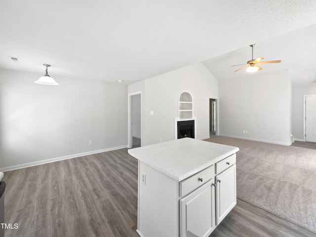 5612 Tealbrook Dr, Raleigh, NC 27610 - kitchen with open floor plan, ceiling fan, vaulted ceiling, light countertops, and built in shelves