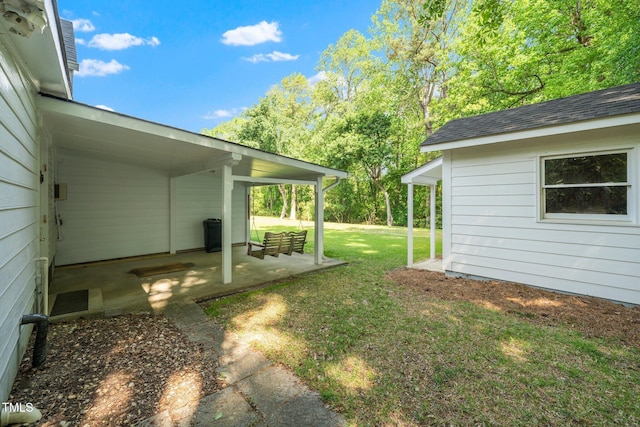 view of grassy yard with a patio