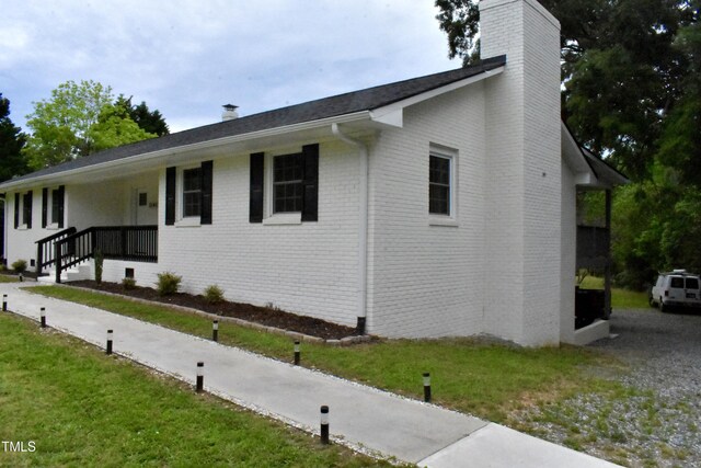 3141 Wagoner Ln Unit 09, Graham, NC 27253 - view of front of home featuring a chimney and brick siding