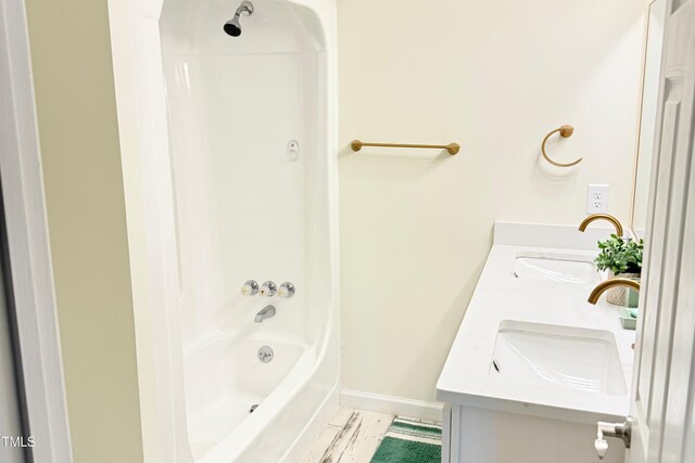 3141 Wagoner Ln Unit 09, Graham, NC 27253 - full bathroom featuring double vanity, baseboards, and shower / bathtub combination