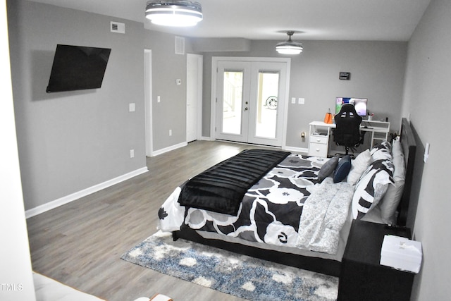 3141 Wagoner Ln Unit 09, Graham, NC 27253 - bedroom featuring french doors, wood finished floors, baseboards, and access to exterior