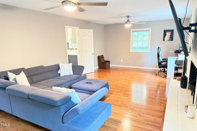 3141 Wagoner Ln Unit 09, Graham, NC 27253 - living room featuring a ceiling fan, light wood-type flooring, and baseboards