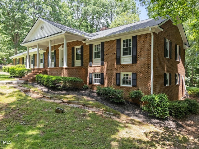 3204 Manor Ridge Dr, Raleigh, NC 27603 - view of front of home featuring brick siding, a chimney, and covered porch
