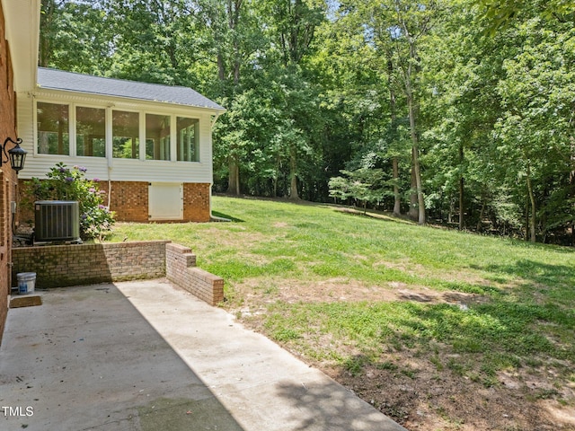 3204 Manor Ridge Dr, Raleigh, NC 27603 - view of green lawn featuring central AC and a patio