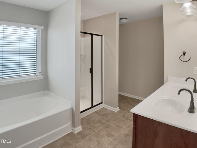 bathroom featuring a shower stall, a bath, double vanity, tile patterned floors, and baseboards
