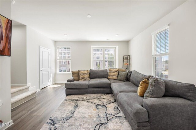 926 Romeria Dr, Durham, NC 27713 - living area with wood finished floors, baseboards, and stairs
