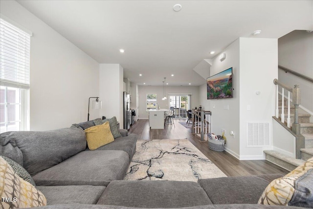 926 Romeria Dr, Durham, NC 27713 - living area featuring wood finished floors, stairway, baseboards, and recessed lighting