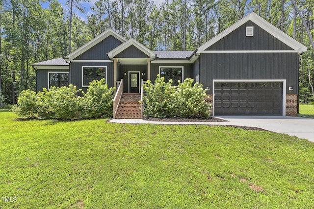 13417 New Light Rd, Raleigh, NC 27614 - view of front facade with a garage, concrete driveway, and a front lawn