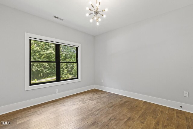 13417 New Light Rd, Raleigh, NC 27614 - unfurnished room with a chandelier and wood finished floors