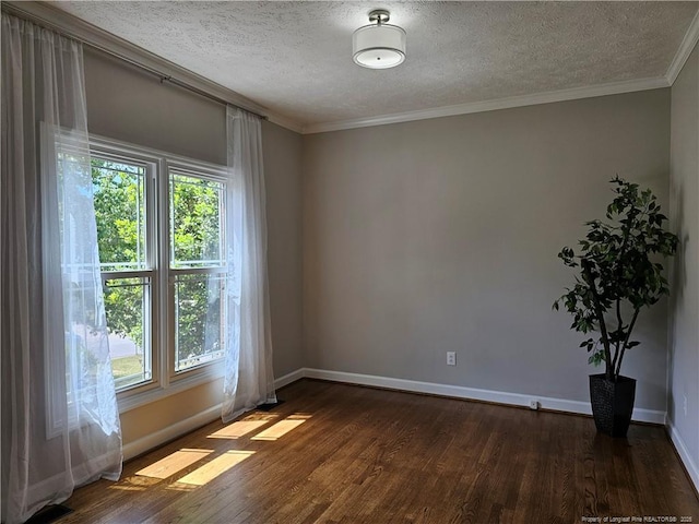 unfurnished room with a textured ceiling, dark wood-type flooring, baseboards, and crown molding