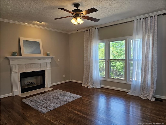living room with wood finished floors, a textured ceiling, baseboards, a ceiling fan, and crown molding