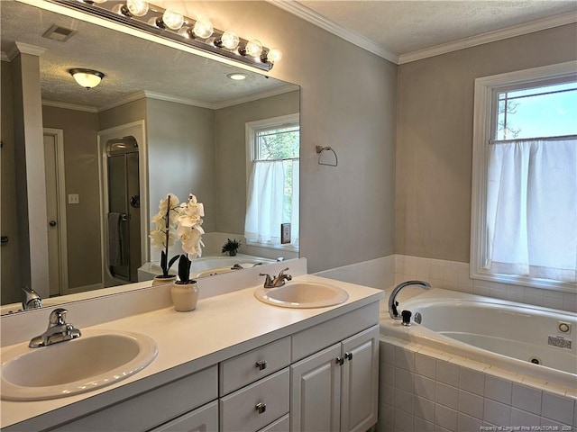 full bathroom featuring a whirlpool tub, double vanity, a stall shower, and a textured ceiling