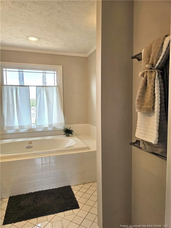 bathroom featuring a bath, crown molding, tile patterned flooring, and a textured ceiling