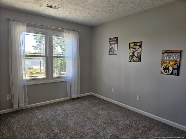 carpeted empty room featuring baseboards and a textured ceiling