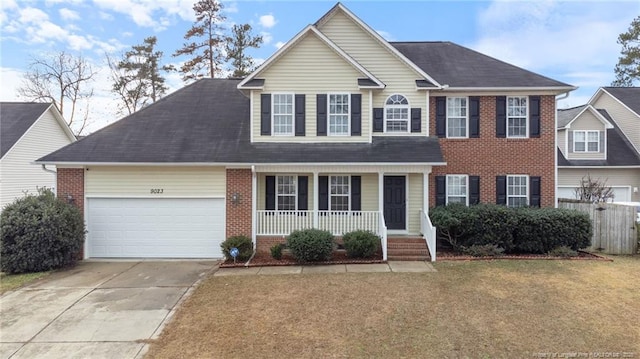view of front of home with a porch, concrete driveway, a garage, and brick siding