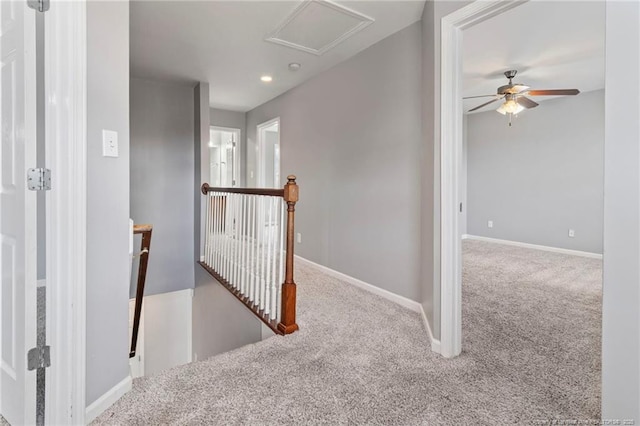 corridor featuring an upstairs landing, carpet, baseboards, recessed lighting, and attic access