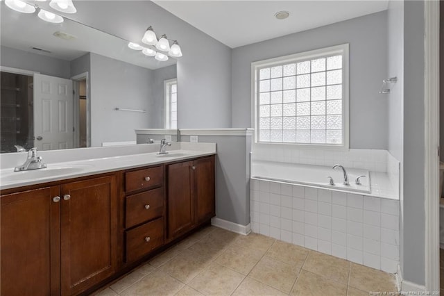 bathroom with a bath, tile patterned flooring, and double vanity