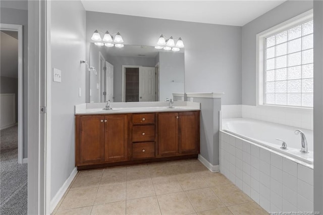 full bathroom featuring double vanity, a garden tub, tile patterned flooring, and baseboards