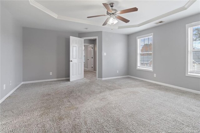 9023 Grouse Run Ln, Fayetteville, NC 28314 - unfurnished bedroom featuring a raised ceiling, crown molding, multiple windows, and carpet floors