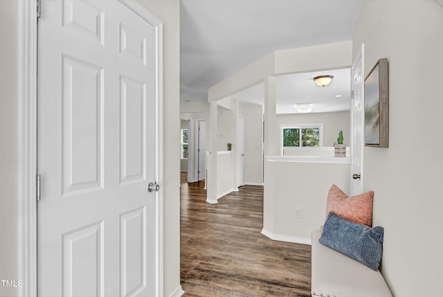 hallway featuring wood finished floors and baseboards