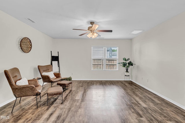 sitting room featuring wood finished floors, a ceiling fan, and baseboards