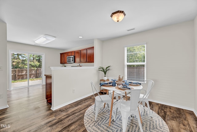 dining room featuring baseboards and dark wood finished floors