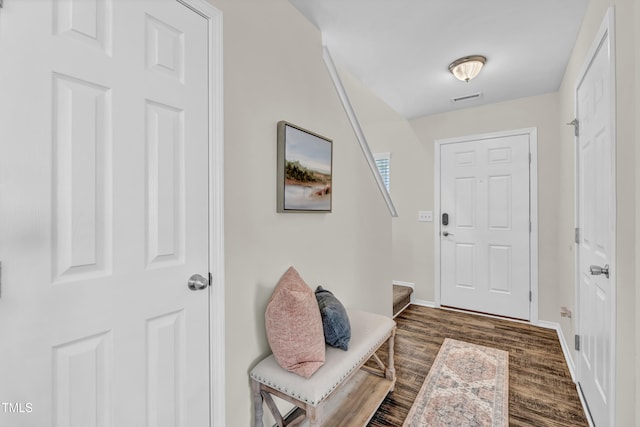 doorway featuring dark wood finished floors and baseboards