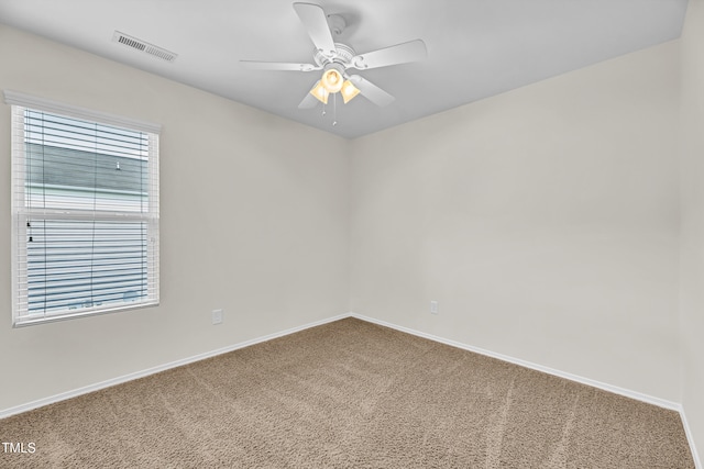 unfurnished room with carpet floors, baseboards, and a ceiling fan