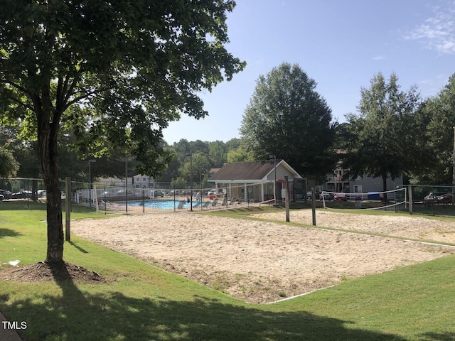 view of property's community featuring volleyball court and a swimming pool