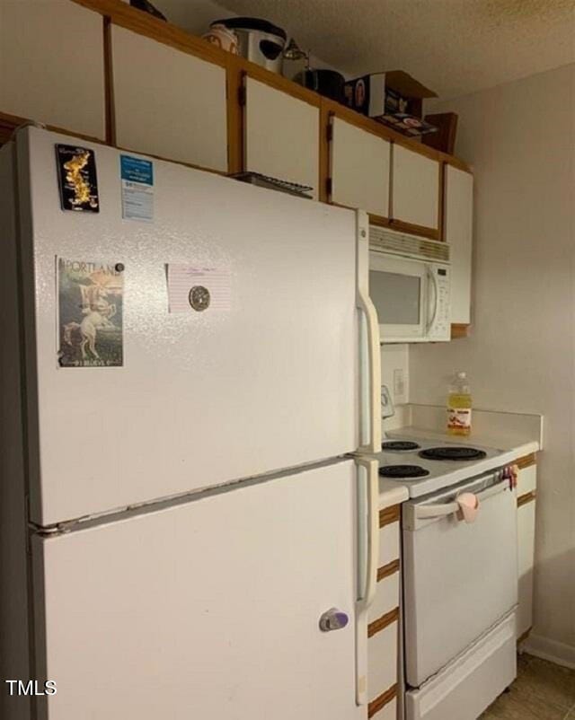 kitchen featuring white appliances and light countertops