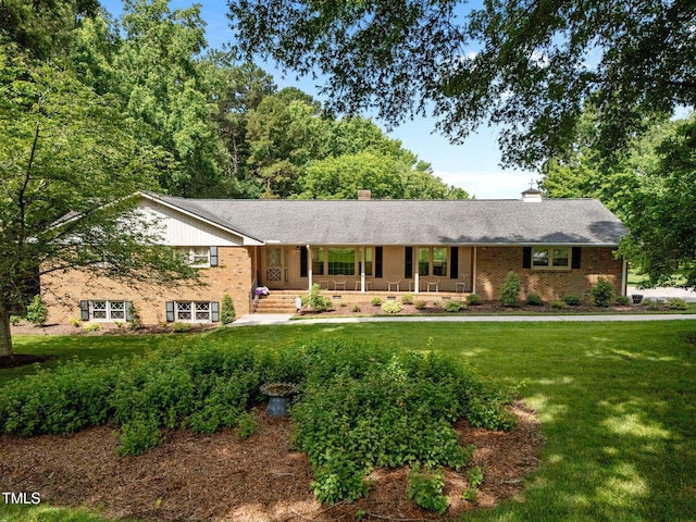913 Milton Rd, Durham, NC 27712 - single story home featuring a porch, brick siding, a front lawn, and a chimney